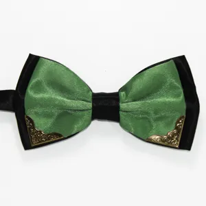 Detail shot of a green and black double layer bow tie featuring vintage metal decorative corners.