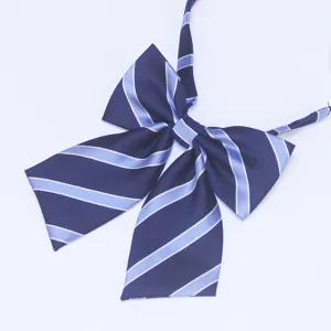 Detailed view of dark blue JK uniform bow tie with light blue stripes and adjustable neck strap.