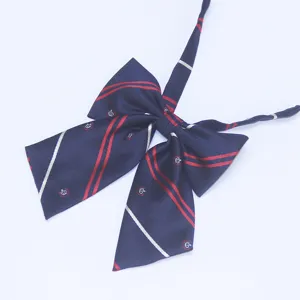 Navy blue JK bow tie for women students, featuring red stripes and cute crown print design.