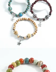 Close up view of colorful ceramic beads and star pendants on ethnic style beaded bracelets.