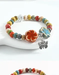 Ceramic beaded bracelet with colorful ceramic flower and cute silver butterfly charm for women.
