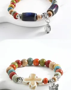 Close-up detail of the ethnic style ceramic beaded bracelet with cross pendant and colorful beads.