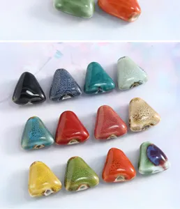 Detailed view of colorful glazed ceramic triangle beads, perfect for DIY jewelry making.