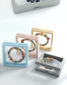 Detailed close-up of colorful ceramic bead bracelets displayed inside transparent floating frames.