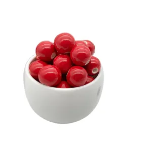 Red ceramic loose beads in bowl for DIY jewelry making handmade bracelets and hair accessories