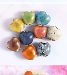 Close-up of colorful ceramic heart beads for DIY jewelry making and handmade bracelets.