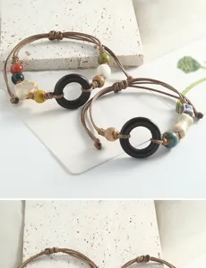 Detail view of retro handmade Jingdezhen ceramic beaded braided bracelet with wooden rings.