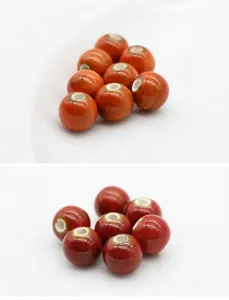 Ceramic loose beads detail shot, featuring vibrant red orange glazed round porcelain beads for DIY crafts.