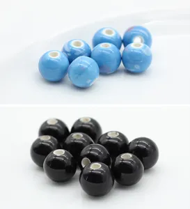 Close-up detail of smooth ceramic round beads, perfect for DIY bracelets and jewelry making.