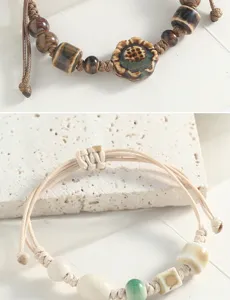 Handmade Chinese style ceramic beaded bracelet detail view, vintage lotus charm and woven cord.