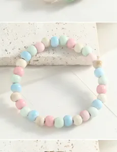 Detailed view of a vintage-style ceramic beaded bracelet, featuring pastel multicolor round beads.