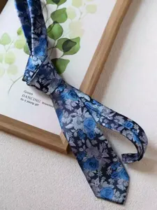 Detailed view of an 8cm blue vintage floral necktie, perfect for business formal and wedding wear.