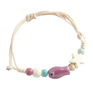 Handmade woven ceramic fish bracelet with colorful beads and star charm, cute and simple style.