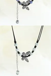 Detail shot of a new Chinese style ceramic butterfly necklace with speckled beads and silver chain.