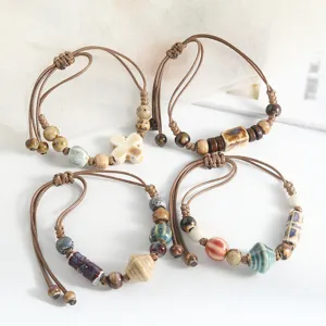 Handmade woven couple bracelet with retro ethnic Jingdezhen ceramic beads and wooden accents.