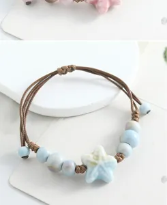 Ceramic star bracelet detail shot featuring blue glazed charm and hand-woven brown rope.