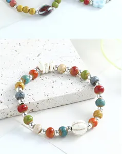 Detailed shot of a Chinese style ceramic beaded bracelet with colorful ceramic and metal spacer beads.