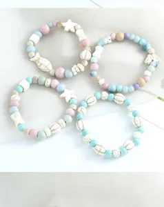 Chic pastel ceramic beaded bracelet set with cute star and fish charms, retro fresh style jewelry.