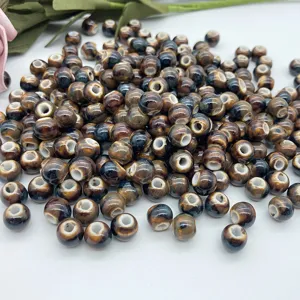 Detailed view of ceramic beads, loose glazed beads with hole for DIY jewelry making accessories.