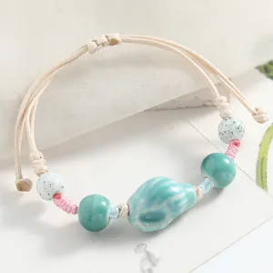 Handcrafted ceramic bead bracelet with braided cord, artistic style, adjustable couple jewelry.
