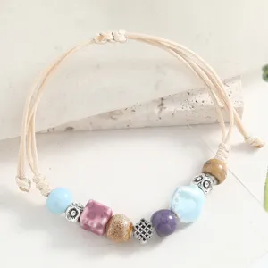 Fresh ceramic beaded bracelet, women woven cord seashell charm jewelry main product view.