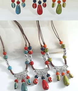 Detailed view of bohemian ceramic drop pendant long sweater chain with multi-color beads.