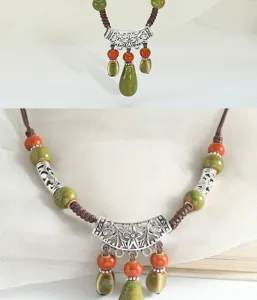 Close-up detail of bohemian vintage ceramic necklace with water drop pendant and woven cord.