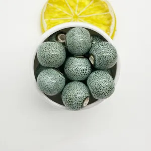 Close-up detail of 12mm green crackle glaze ceramic beads, perfect for DIY jewelry making.