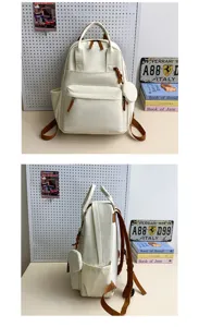 Beiger Studenten-Canvas-Rucksack mit Fronttasche, Seitentaschen und kleinem Münztaschen-Set.