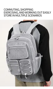 Sac à dos en filet gris décontracté avec grandes poches et grande capacité pour les étudiants.