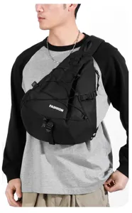 Close up detail of the black tactical nylon chest sling bag with front bungee cord and print.