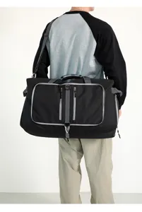 Grande bolsa de viaje negra con ribetes grises, ideal para deportes y uso en el gimnasio.