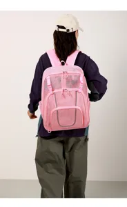 Detailed view of the pink mesh backpack featuring durable hollow design and reflective straps.