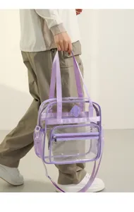 Transparent PVC shoulder bag clear detail showing front zipper pocket and purple webbing straps.