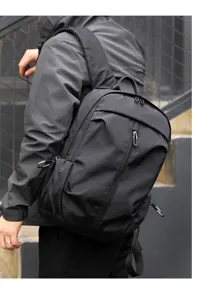 Close-up detail of the black urban backpack, highlighting sturdy straps, zippers, and durable fabric.