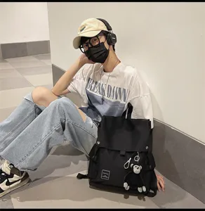Casual canvas backpack for students, minimalist flap design, ideal for school and daily travel.