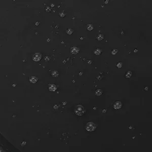 Détail du tissu de sac à dos en nylon imperméable noir affichant des gouttes d'eau résistantes.