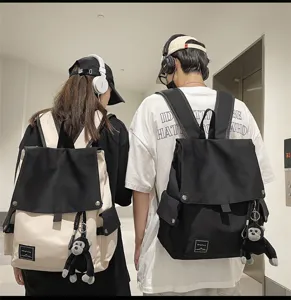 Canvas flap backpack for students, casual school rucksack with cute monkey pendant.