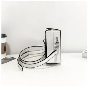 White box crossbody bag for women, minimalist shoulder bag with black trim and stylish design.
