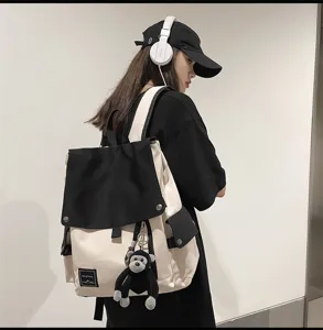 Casual canvas backpack with flap design and black white color block for campus daily use.