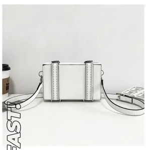 White 2D cartoon comic style crossbody box bag with black edge lines and shoulder strap.