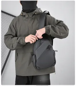 Detailed view of trendy black sling backpack showing multi-functional design and crossbody wear.