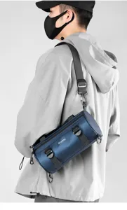 Detail view of stylish functional waterproof cylinder crossbody shoulder bag for men daily.