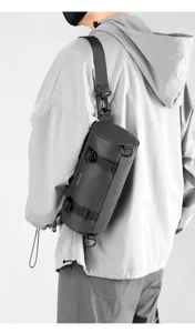 Stylish dark grey cylindrical crossbody chest bag with durable strap for urban men's daily wear.