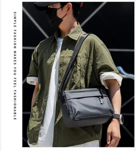 Men's waterproof grey messenger bag, stylish casual crossbody shoulder bag for daily commuting.