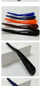 Plastic shoe horn detail view showing multi-color options, smooth surface and hanging hole.