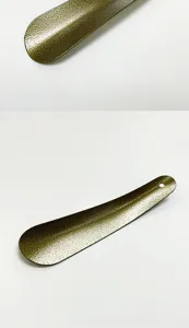 Stainless steel shoehorn detail showing hammered texture and hanging hole for easy use.