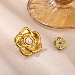 Exquisite gold-tone camellia flower brooch detail with central pearl and clasp pin.