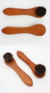 Wooden handle soft bristle cleaning brush detail view for leather polishing and dust removal.