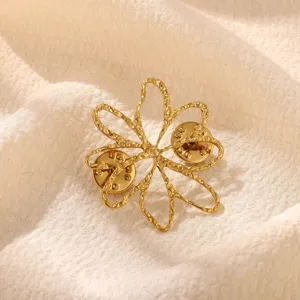 Gold hollow flower brooch pin detail view, featuring delicate textured petals and double pin back.